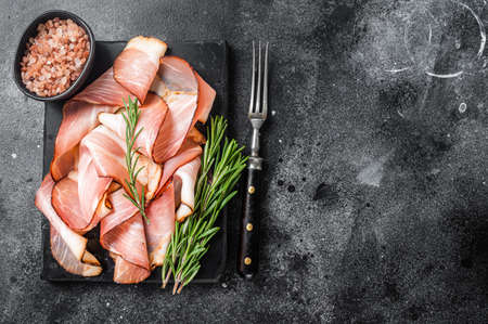 Pork Black Forest Ham Slices on marble board. Black background. Top view. Copy spaceの写真素材