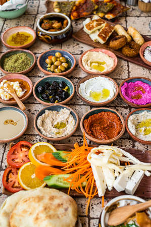 Delicious Turkish family breakfast table with pastries, vegetables, greens, spreads, cheeses, fried eggs, jams. Top viewの写真素材