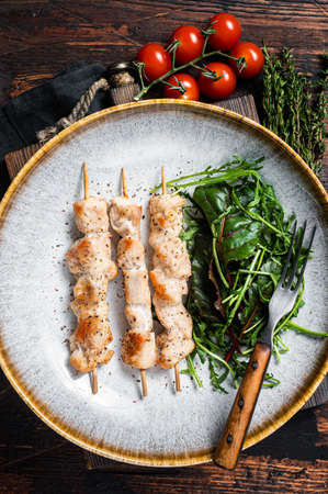 Chicken skewers souvlaki, grilled meat shish kebab skewers. Wooden background. Top viewの写真素材