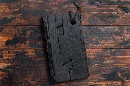 Black wooden Cutting board on kitchen table. Wooden background. Top view. Copy spaceの写真素材