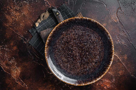 Table setting with vintage empty black plate on rustic wood. Dark background. Top view. Copy spaceの写真素材
