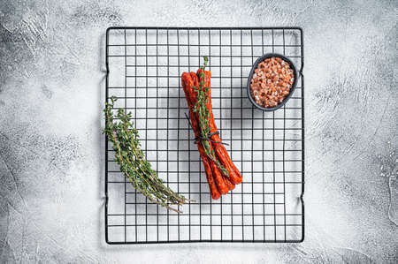 Kabanos or cabanossi traditional Polish thin dry smoked sausage with herbs. white background. top view.の写真素材