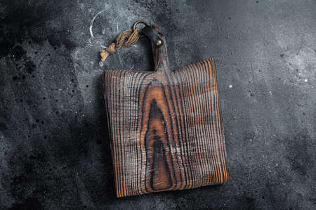 Cooking background with old empty cutting board. Black background. top view. copyspace.の写真素材