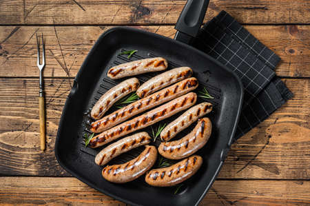 Grilled homemade sausages with Beef, pork, lamb and chicken mince meat in a grill skillet. wooden background. top view.の写真素材
