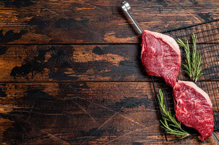 Ready for cooking raw picanha barbecue skewer. Wooden background. Top view. Copy spaceの写真素材