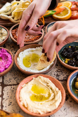 Women eating Traditional Turkish Village Breakfast served in restaurant. top view.の写真素材