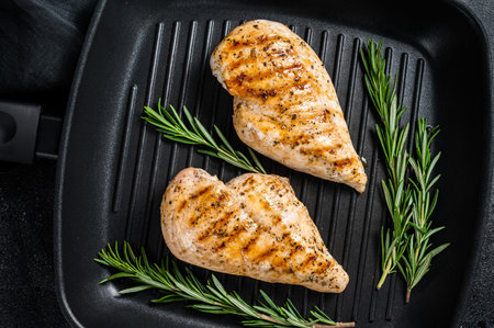 Grilled healthy chicken breasts cooked on a grill pan. Black background. top view.の写真素材