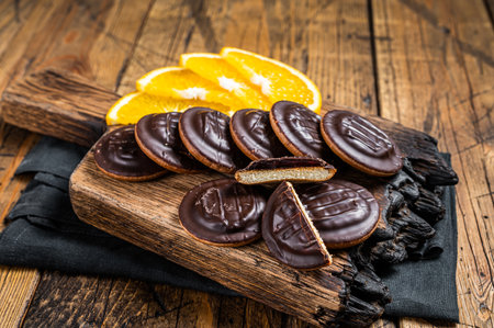 Chocolate Jaffa Cakes with Orange Flavored Marmalade. wooden background. top view.の写真素材