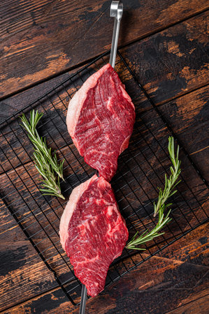 Ready for cooking raw picanha barbecue skewer. Wooden background. Top viewの写真素材
