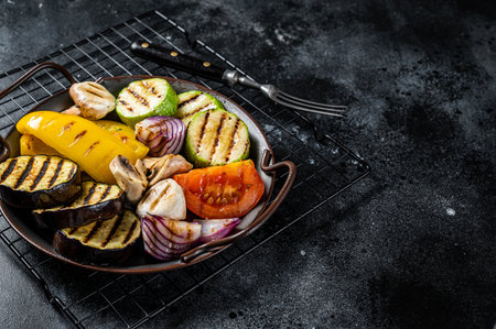 Grilled vegetables, bell pepper, zucchini, eggplant, onion and tomato. Black background. top view. copyspace.の写真素材