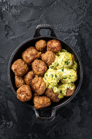 Skillet with Swedish beef Meatballs with Cream Sauce. Black background. top view.の写真素材