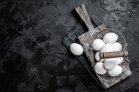 Basket with white chicken eggs. Black background. top view. copyspace.の写真素材