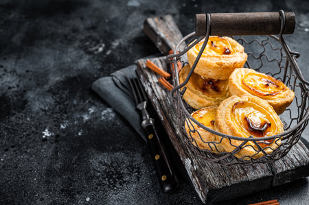 Traditional Lisbon Pasteis de nata in a basket. Black background. top view. copyspace.の写真素材