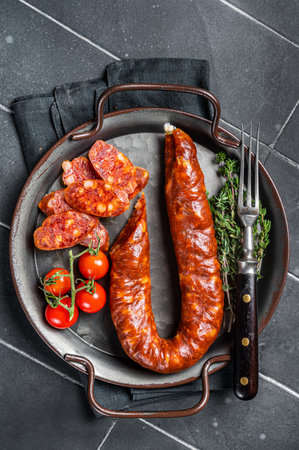 Sliced Chorizo sausage, slices of dry cured pork with herbs and spices. Black background. top view.の写真素材