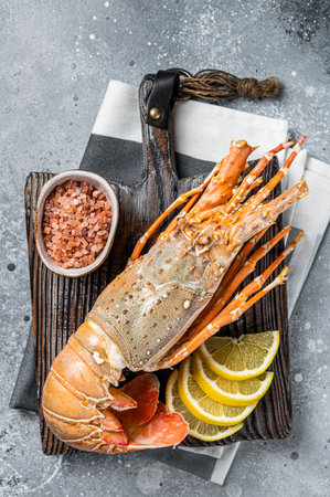 Cooked Spiny lobster or sea crayfish on a wooden board. gray background. top view.の写真素材