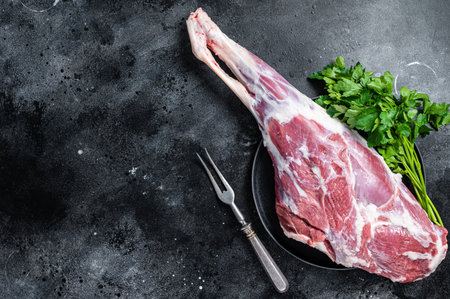 Ready for cooking raw lamb mutton leg with Thigh. Black background. top view. copyspace.の写真素材