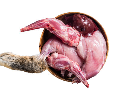 Raw hare game meat, legs and offals in wooden plate with herb. isolated on white backgroundの写真素材