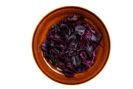 Raw Ruby or red chard salad Leafs on a rustic plate. isolated on white background