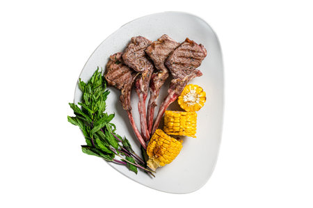 Grilled lamb chops steaks in a plate with corn and tomato. isolated on white backgroundの写真素材