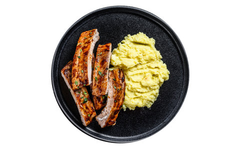 Sliced BBQ grilled pork rack spare ribs on a plate with mash potato. isolated on white backgroundの写真素材