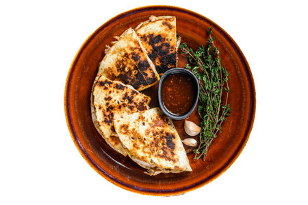 Mexican quesadilla with chicken, paprika, cheese and cilantro on wooden cutting board. isolated on white backgroundの写真素材