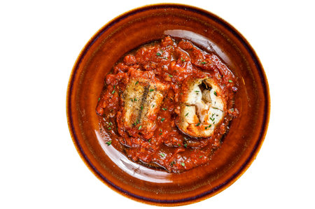 Roast grenadier white fish fillet with tomato sauce in a plate. isolated on white backgroundの写真素材