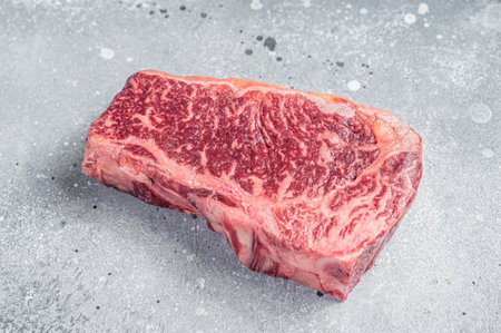 Raw Wagyu striploin or New York steak on a butcher table. gray background. top view.の写真素材