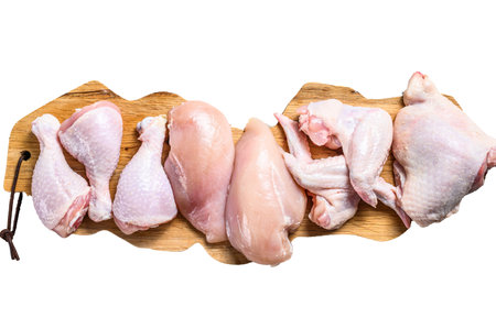 Raw uncooked chicken meat on a cutting board. isolated on white background.