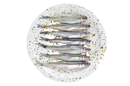 Raw smelt on a plate. isolated on white background