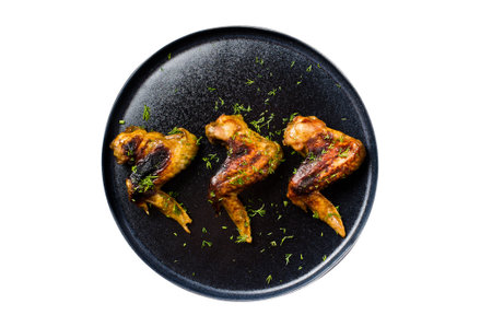 Chicken wings BBQ on the black plate. isolated on white background.の写真素材