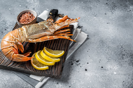 Cooked Spiny lobster or sea crayfish on a wooden board. gray background. top view. copyspace.の写真素材