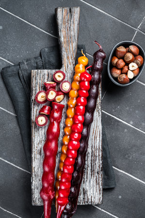 Georgian sweets Churchkhela with sap and hazelnuts. Black background. top view.の写真素材