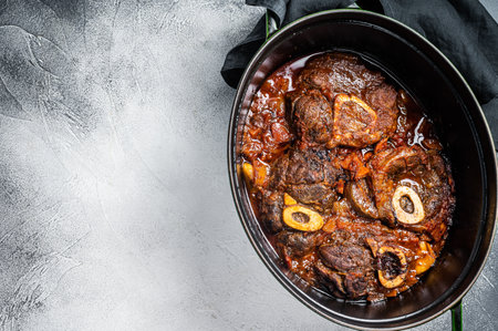 Osso buco cross cut veal shank braised with tomatoes and spices, beef meat Ossobuco. White background. Top view. Copy spaceの写真素材