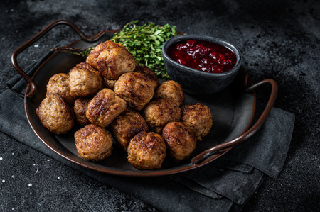 Homemade Swedish meatballs with lingonberries jam. Black background. top view.の写真素材