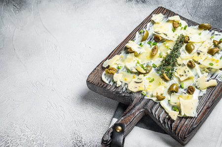 Butter board with herbs, blue cheese, capers, parmesan and olives, Butterboard. White background. Top view. Copy space.の写真素材