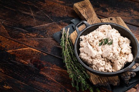 Cod liver Spread with oil in a skillet. Wooden background. Top view. Copy space.の写真素材