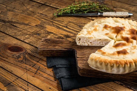 Kubdari Bread, Tasty Flat Bread Stuffed with Spiced meat. Wooden background. Top view. Copy space.の写真素材
