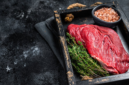 Fresh Raw veal meat with herbs and salt. Black background. top view. copyspace.の写真素材