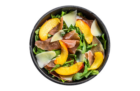 Salad with jamon Iberico, arugula, peach and Parmesan in an iron pan. Isolated, white backgroundの写真素材