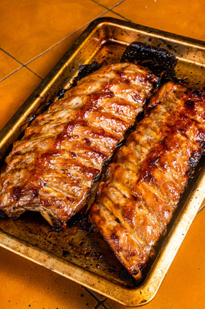Barbecue grilled pork spare ribs. Orange background. Top view.の写真素材