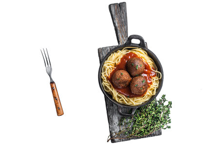 Vegan tomato pasta with plant based Meatballs in a skillet. Isolated, white backgroundの写真素材