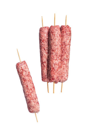 Raw kofta or lula kebabs skewers on butcher board. Isolated, white backgroundの写真素材