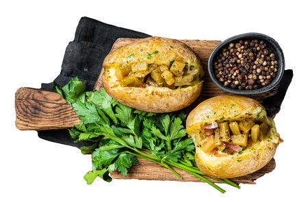 Kumpir, baked Jacket potatoes stuffed with cheese, bacon, salty cucumber, herbs and butter. Isolated, white backgroundの写真素材