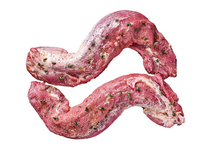 Raw Tenderloin pork fillet ready for cooking, uncooked meat in grill pan with herbs and olive oil. Isolated on white backgroundの写真素材