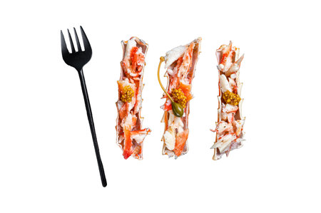 Crab leg meat in a sheel with herbs. Isolated on white background, top viewの写真素材