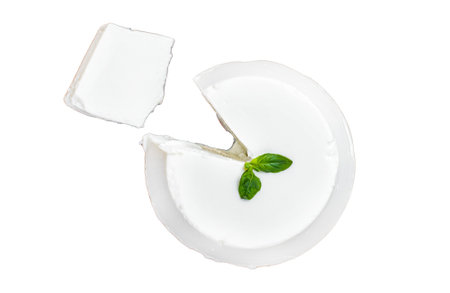 Fresh Ricotta cream Cheese on wooden board with basil. Isolated on white background, top view