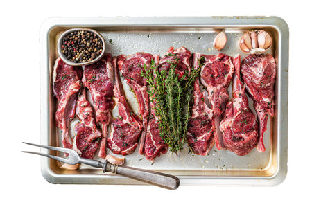 Raw uncooked lamb mutton meat chops steaks with thyme and garlic. Isolated on white background, top view.の写真素材