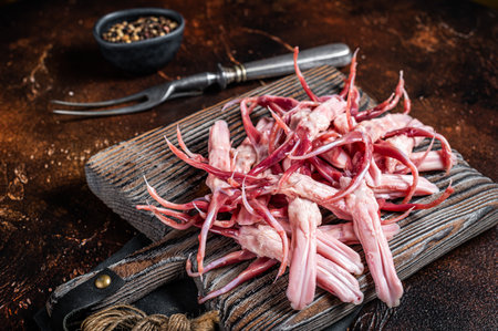 Fresh Raw Duck Tongue, poultry offal. Dark background. Top view.の写真素材