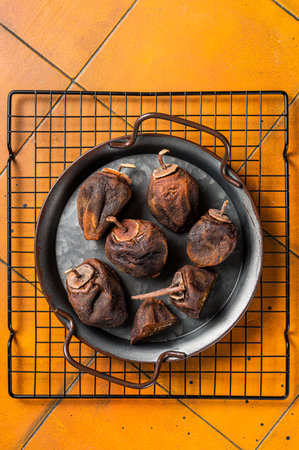 Dried persimmon. Japanese Preserve fruit. Orange background. Top view.