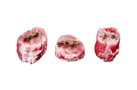 Raw pork medallion steaks with pepper and thyme. Isolated on white background. Top viewの写真素材